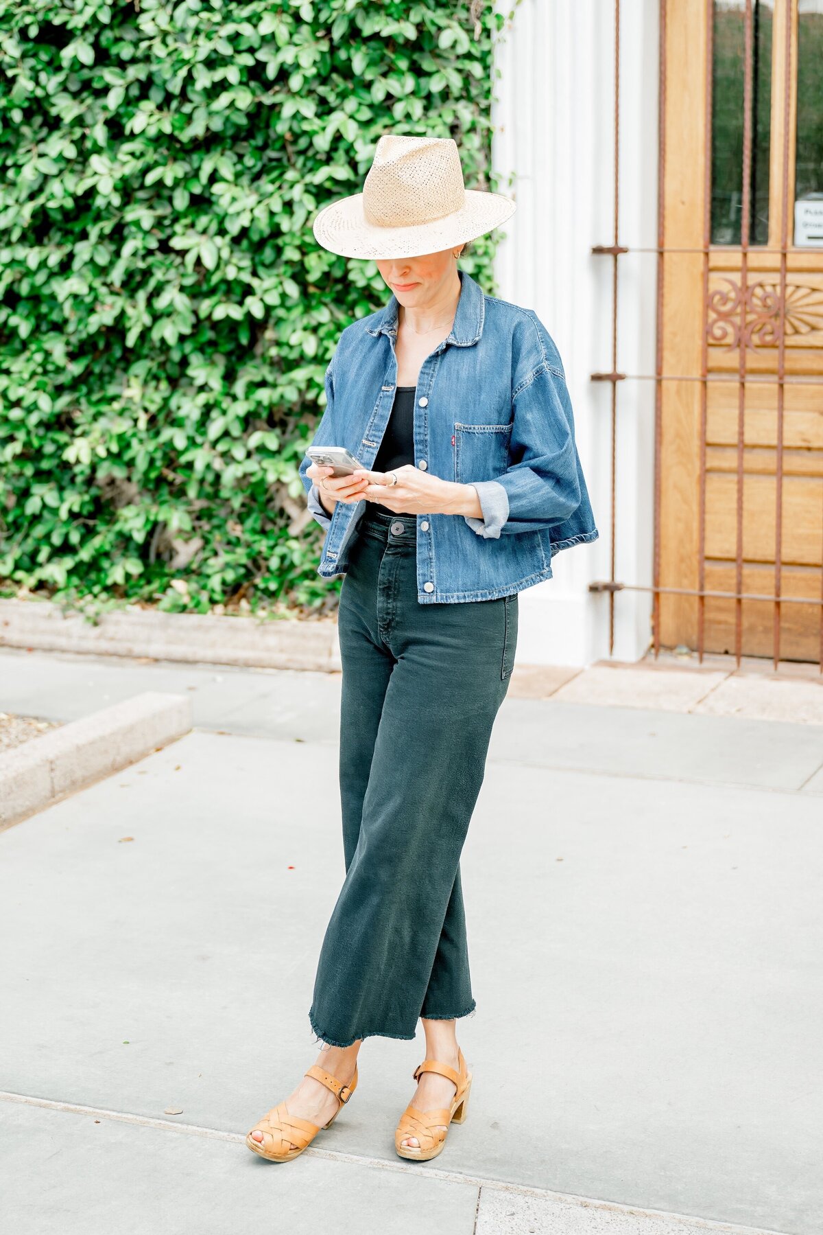 real estate agent looking at her phone in old town scottsdale