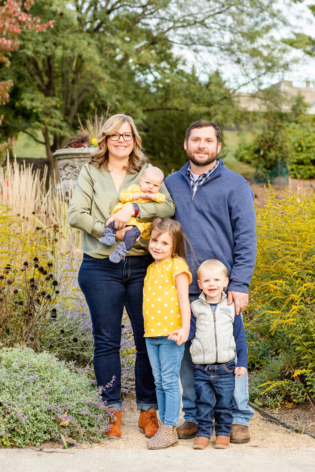 Family standing in flowers smiling