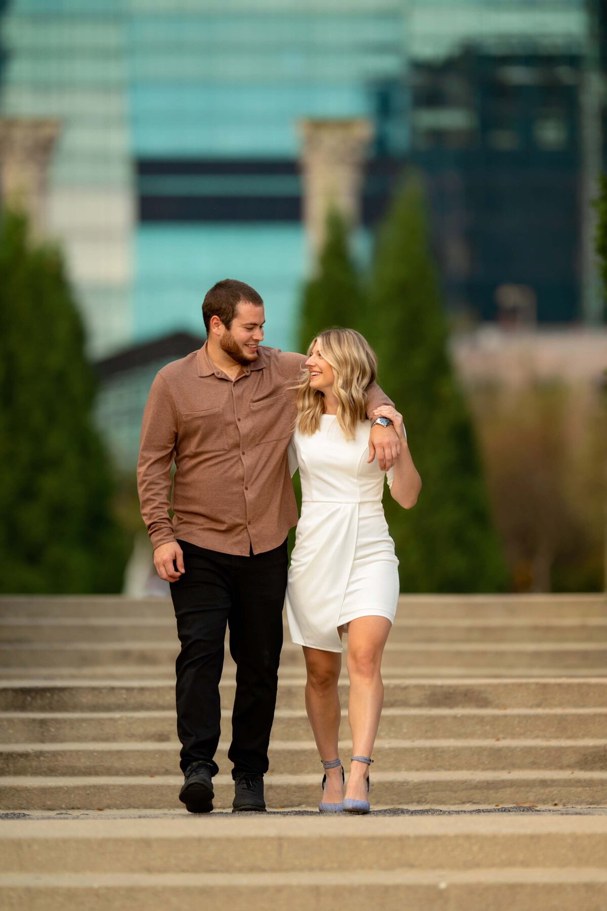 Walking with her future spouse during engagement photo session in Chicago