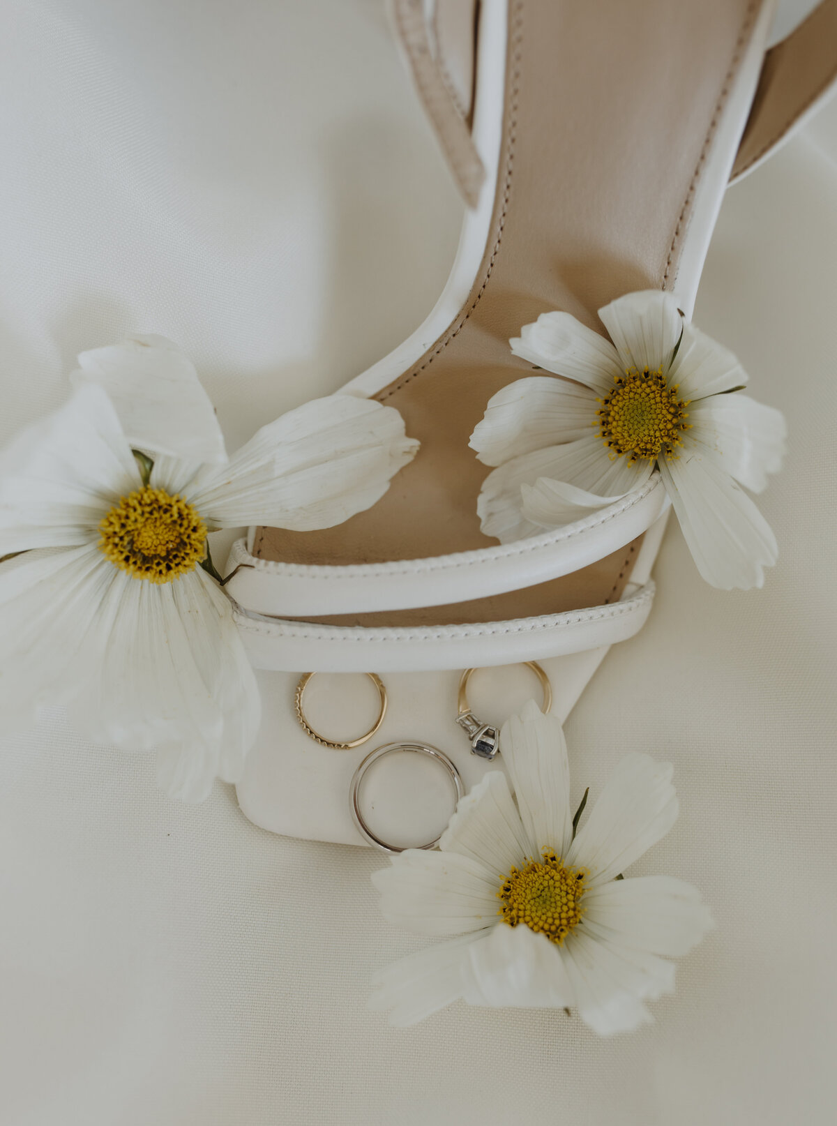 flatlay details with florals and rings