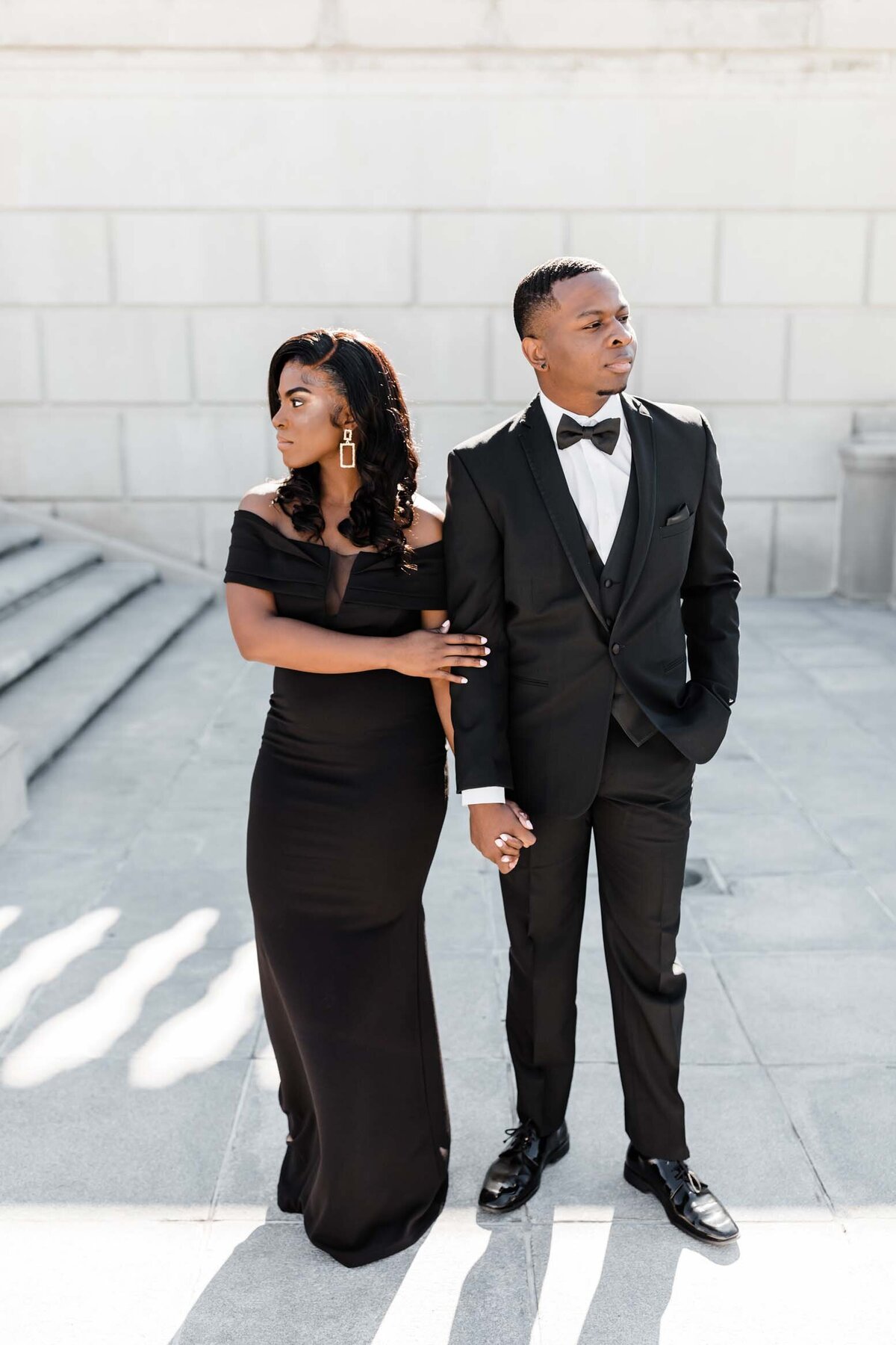 Stylish couple posing in sunlight during their South Bend engagement session.