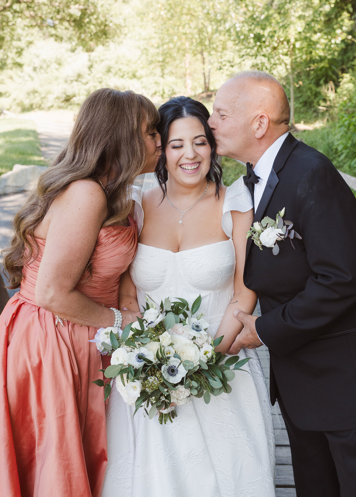 bride and her parents candid wedding portrait
