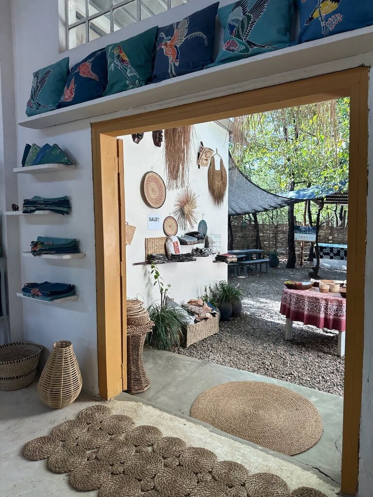 view out of a doorway, african artifacts hanging on the wall 