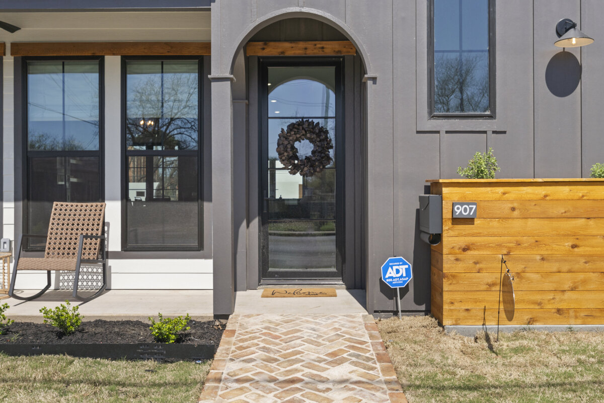 Beautiful front door and patio seating at this two-bedroom, two-bathroom house with wine fridge, firepit, and two master suites located in the heart of the Silo District in Waco, TX.