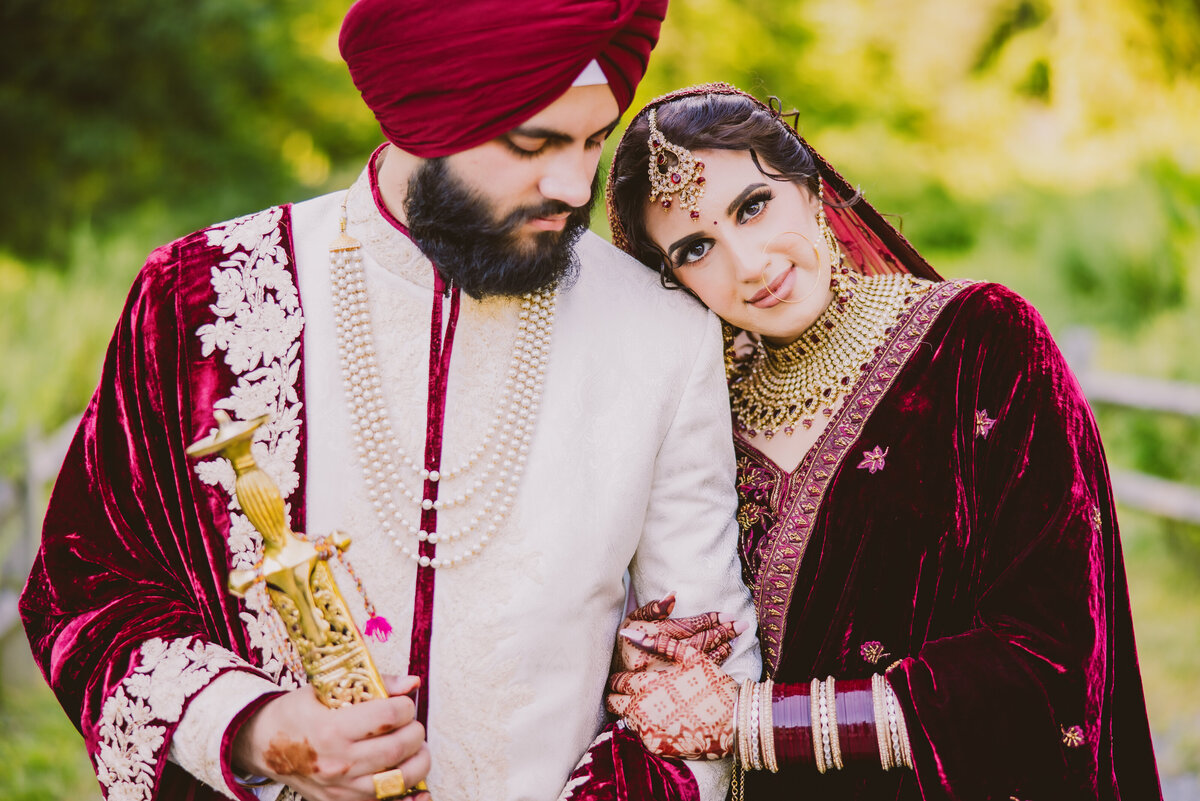 A sikh bride with her head on the groom's shoulder after their anand karaj wedding ceremony in Natirar Park Bridgewater