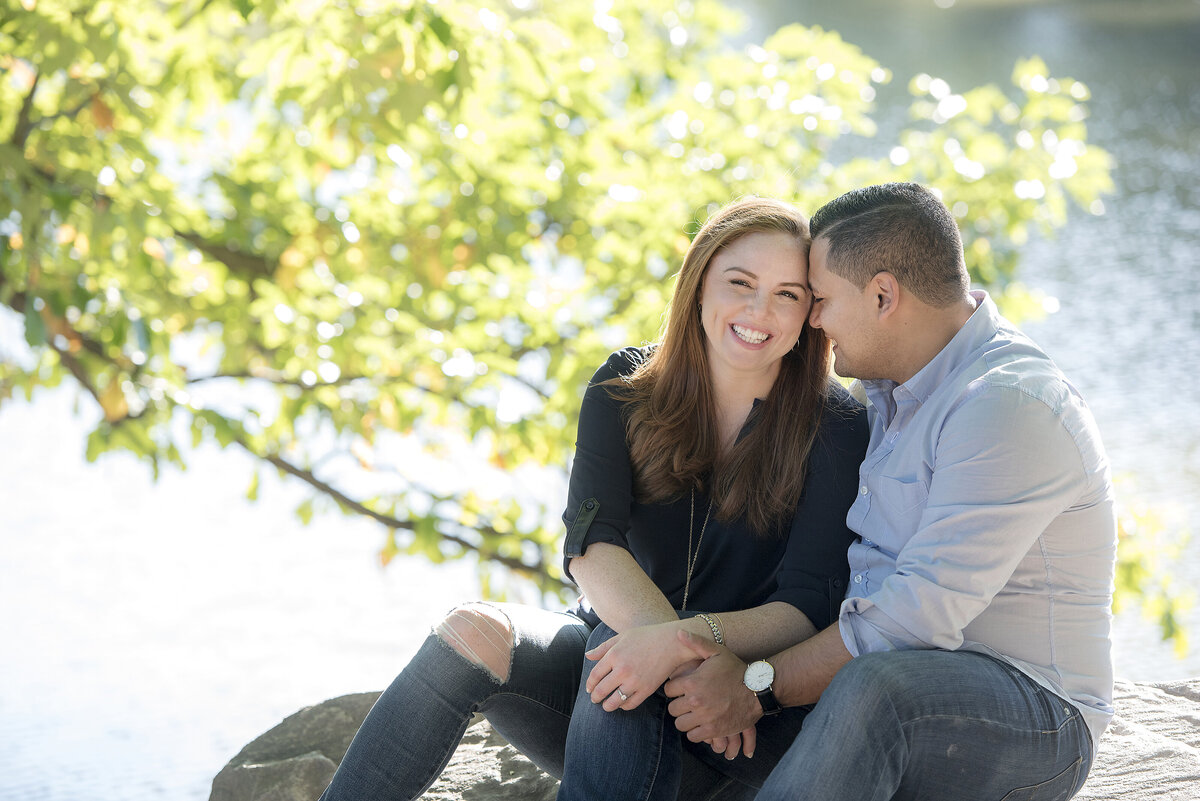 A person sitting next to their partner resting their head on the others 