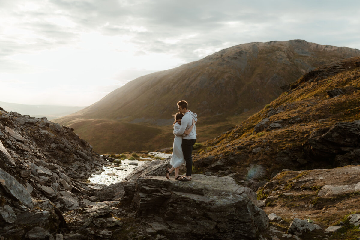 couple kissing on rock