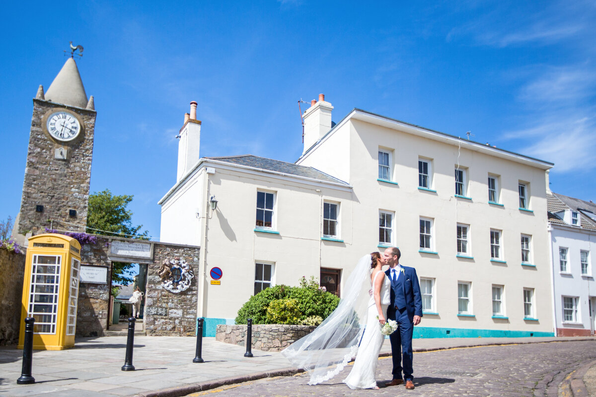 Bride with veil outside costal church