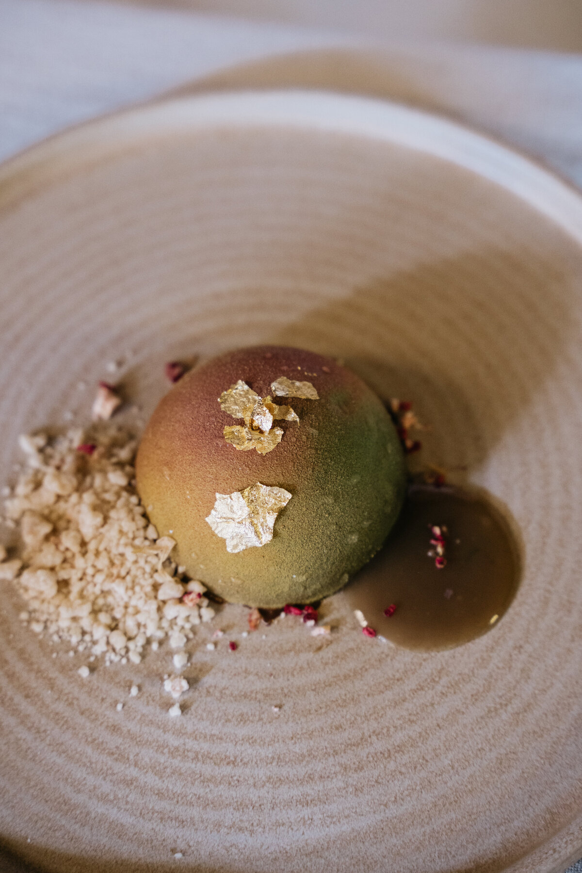 Vegan ravioli dish with greens and edible flowers