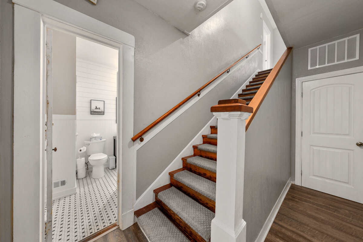 Large staircase in this five-bedroom, 4-bathroom pet-friendly vacation rental house for 12 guests with free wifi, free parking, hot tub, mother-in-law suite, King beds and updated kitchen in downtown Waco, TX.