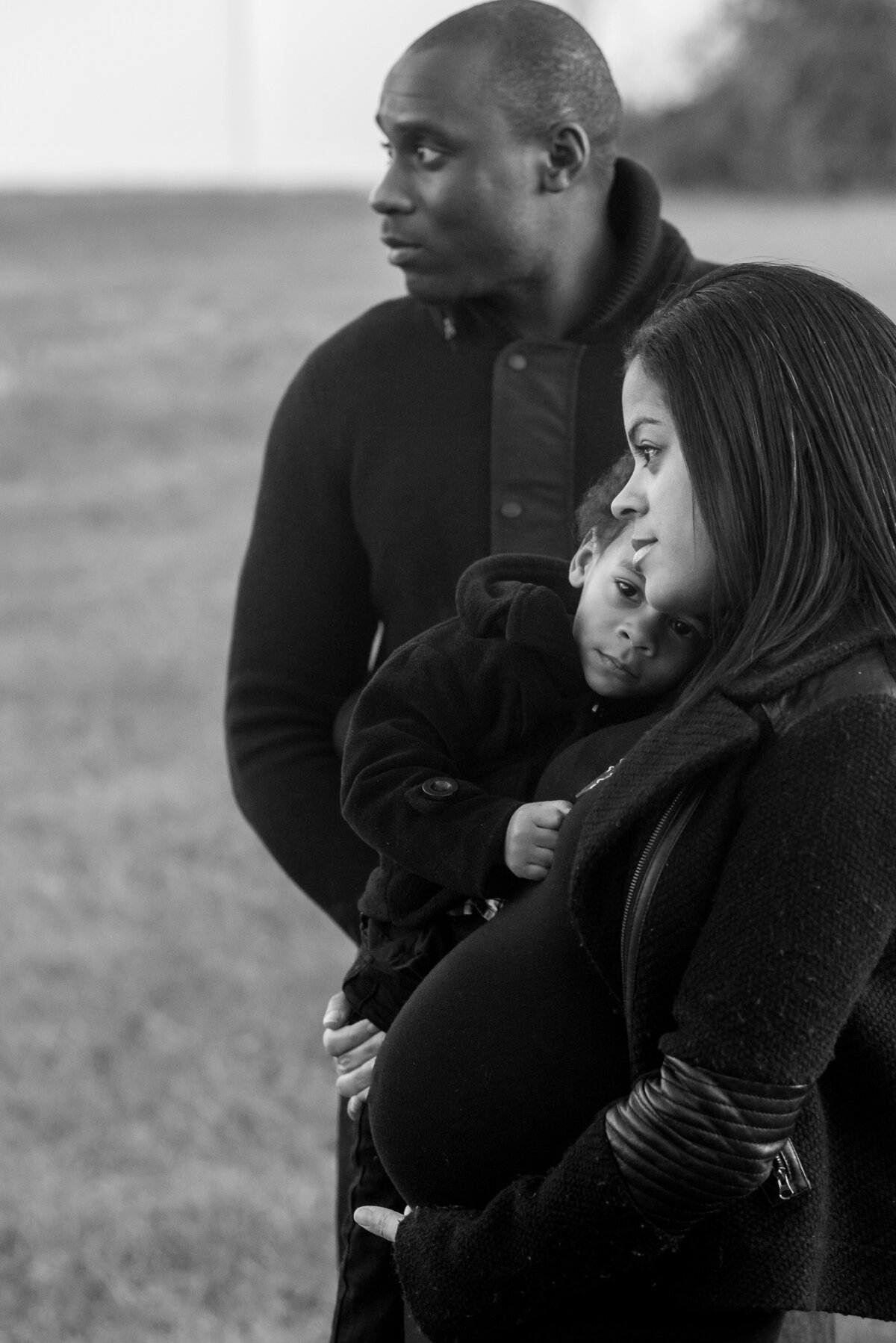 A black and white photo of a family of three for a maternity photo in Austin