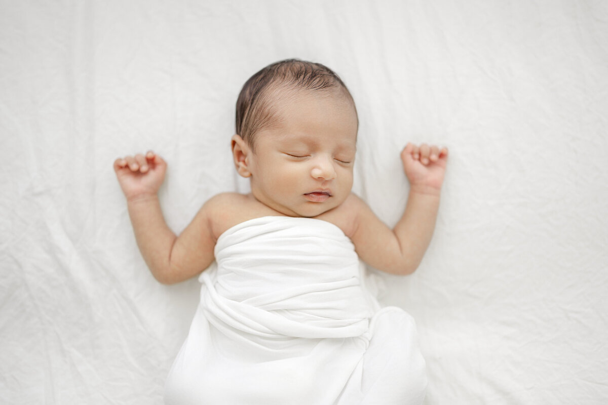 Baby boy swaddled in neutral wrap at Tampa natural light studio