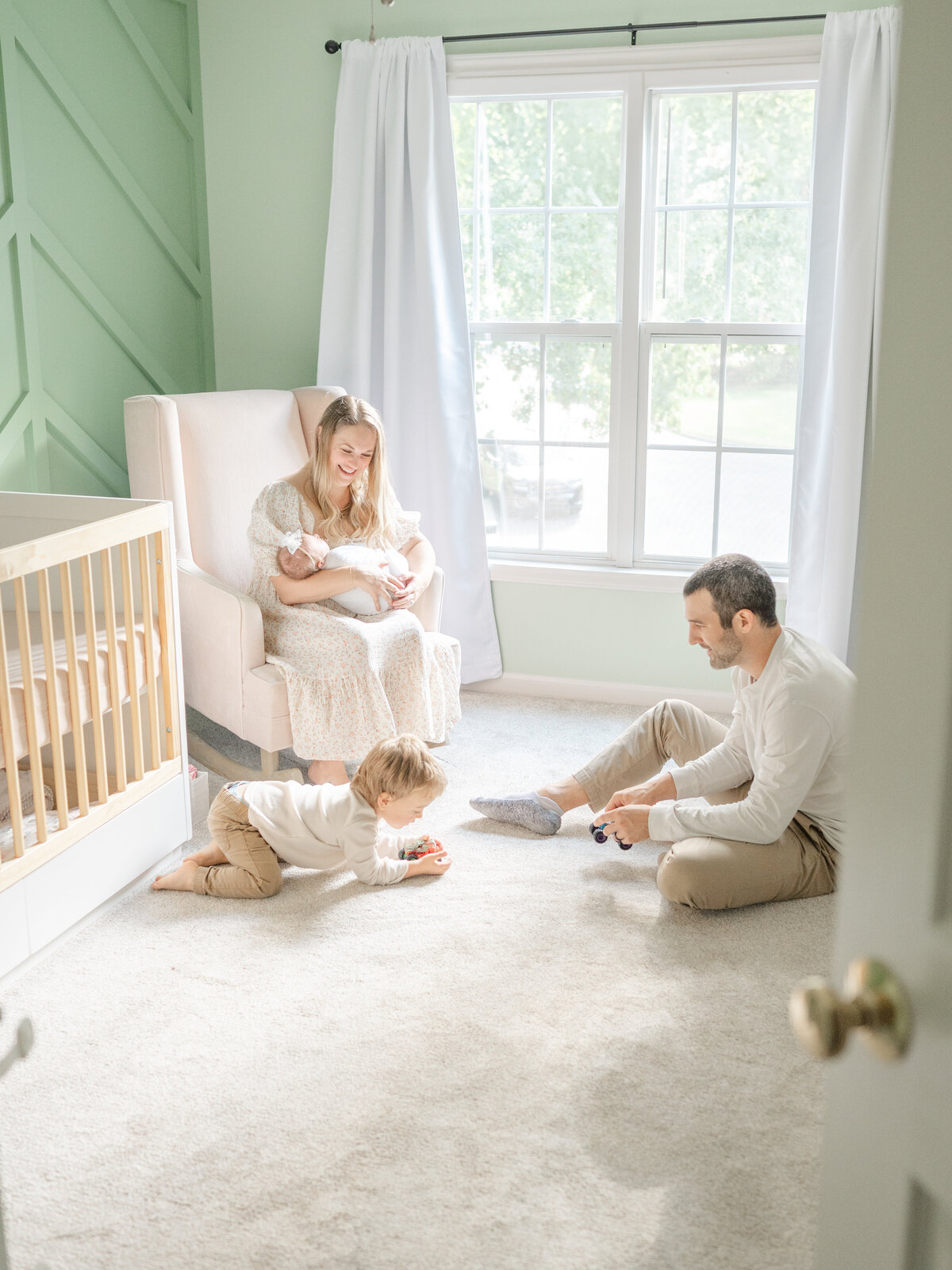 family in nursary by apex newborn photographer
