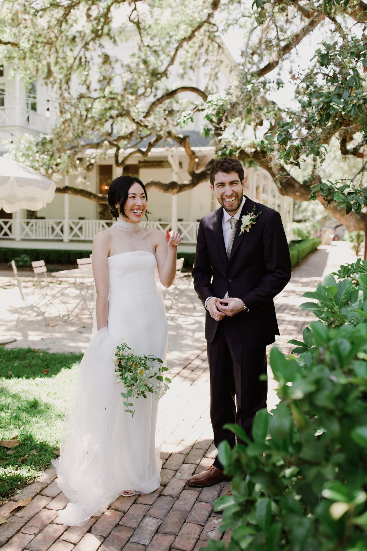 Bride and groom standing by a tree at Mattie's  Austin Wedding