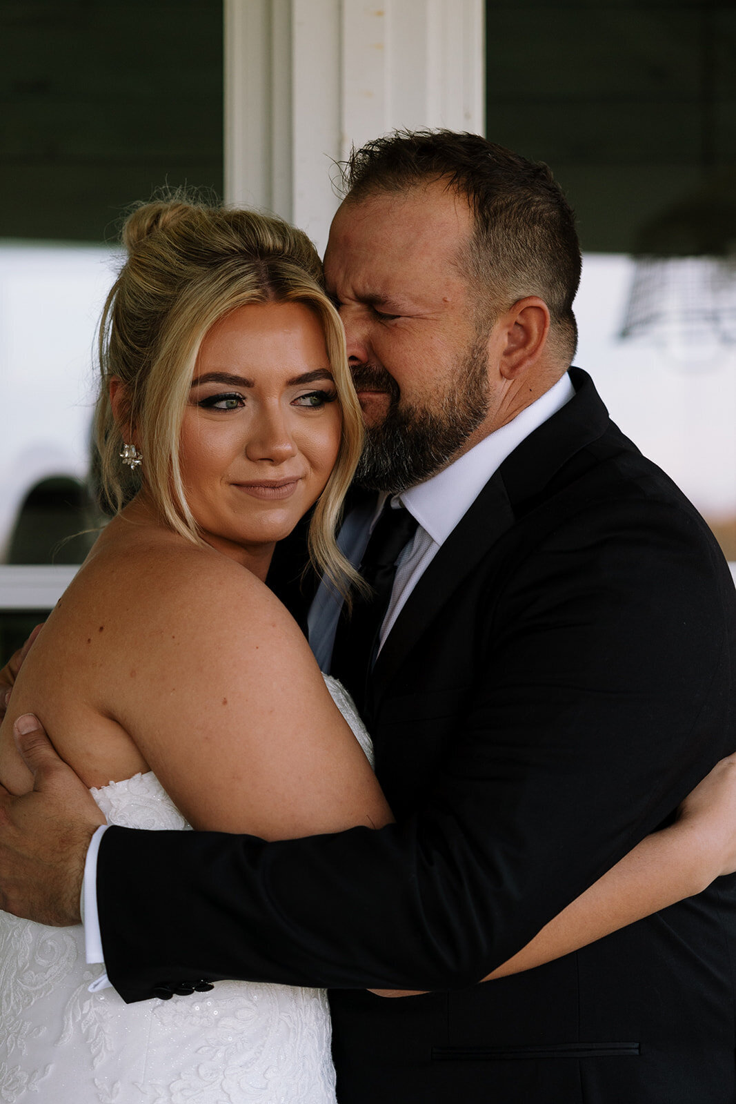 dad hugs and cries with daughter on wedding day
