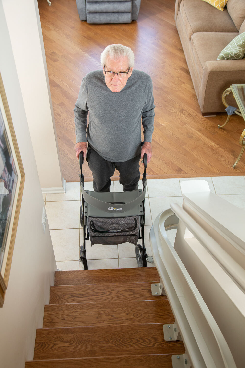 A man is pushing a stroller up a set of stairs