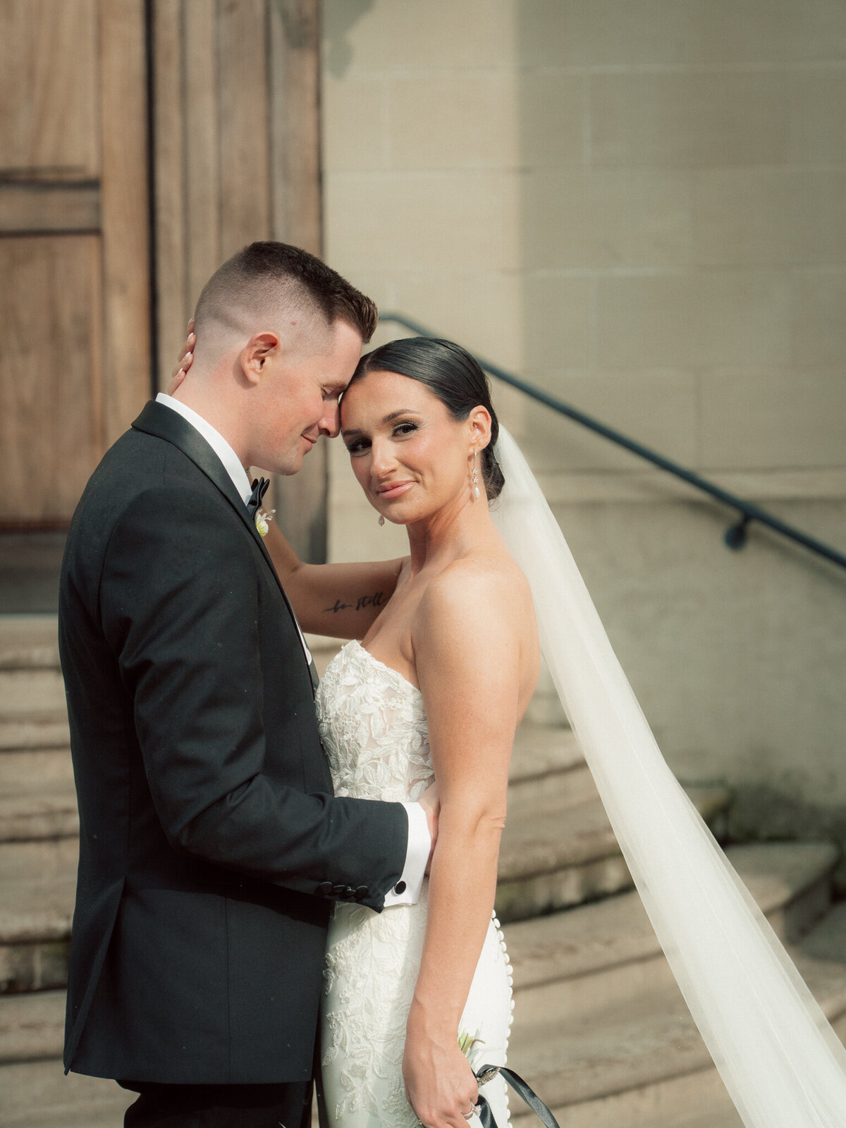 Bride and groom portrait on stone church steps