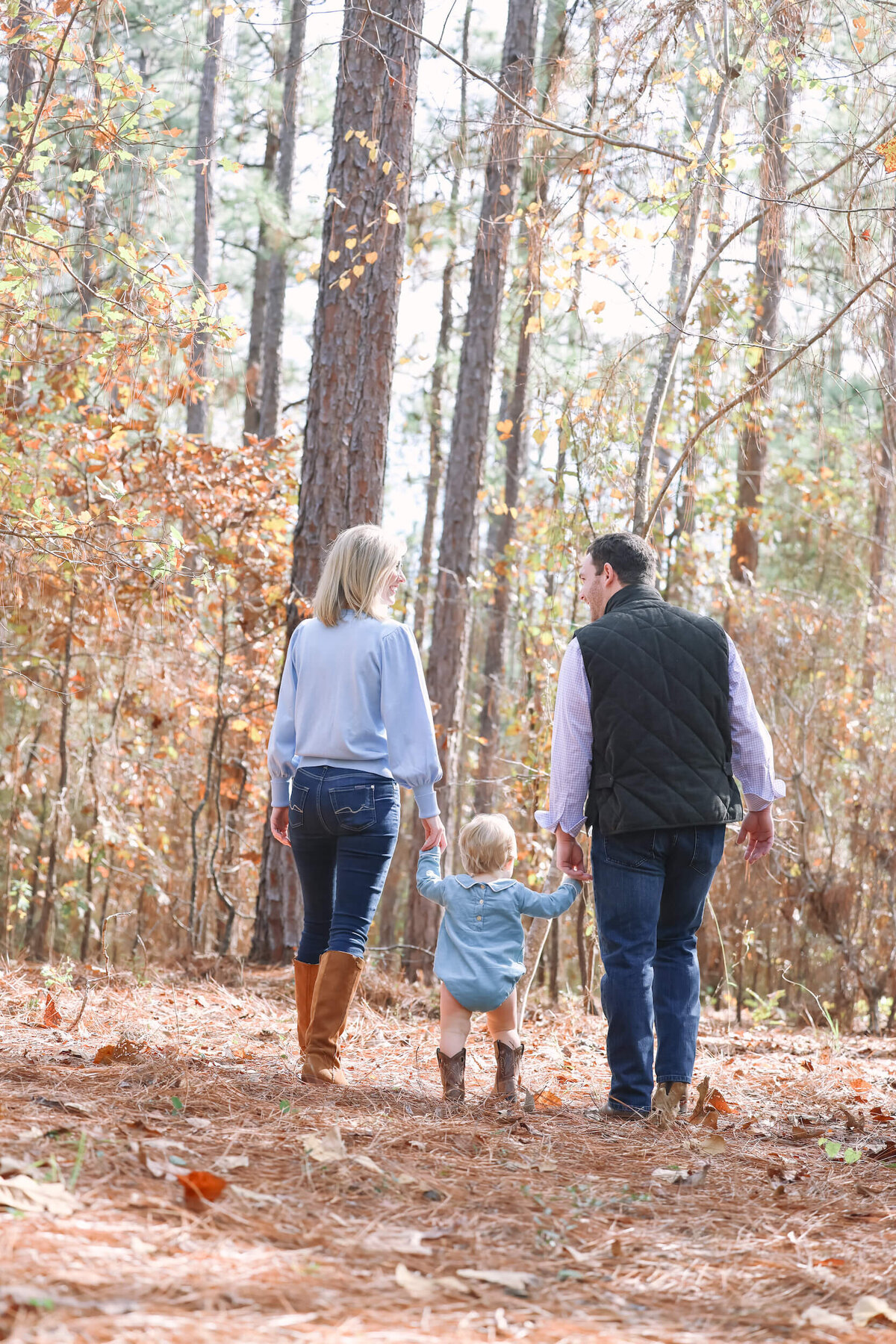 family-of-three-walking-away