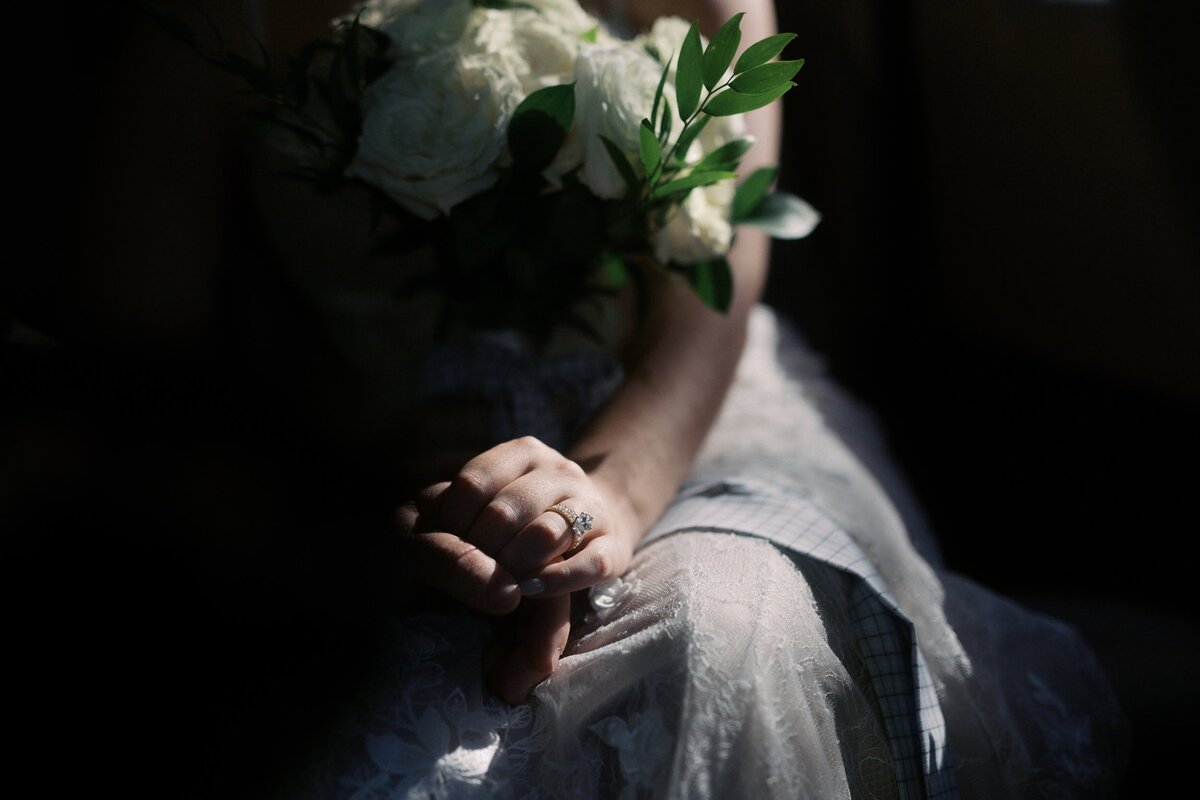 Documentary detail photo of the bride's hand holding the groom's hand inside a cab on the way to Wythe Hotel.