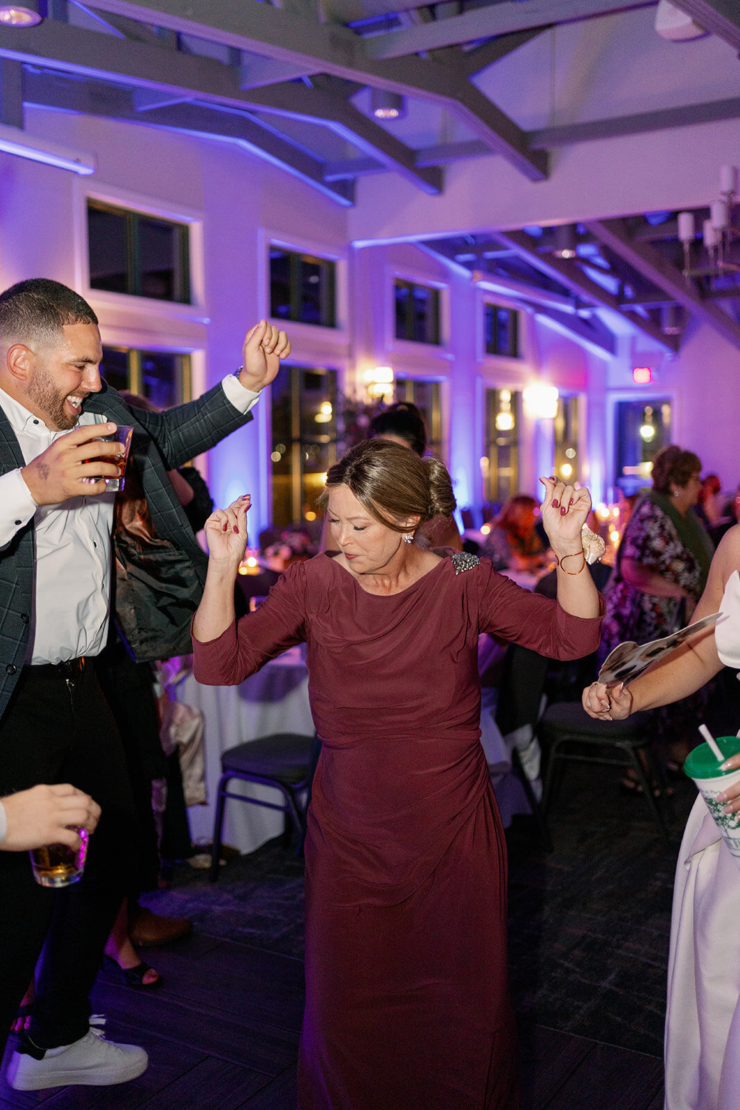 Candid wedding reception dancing at Boatwerks in Holland Michigan with modern documentary-style wedding photography.