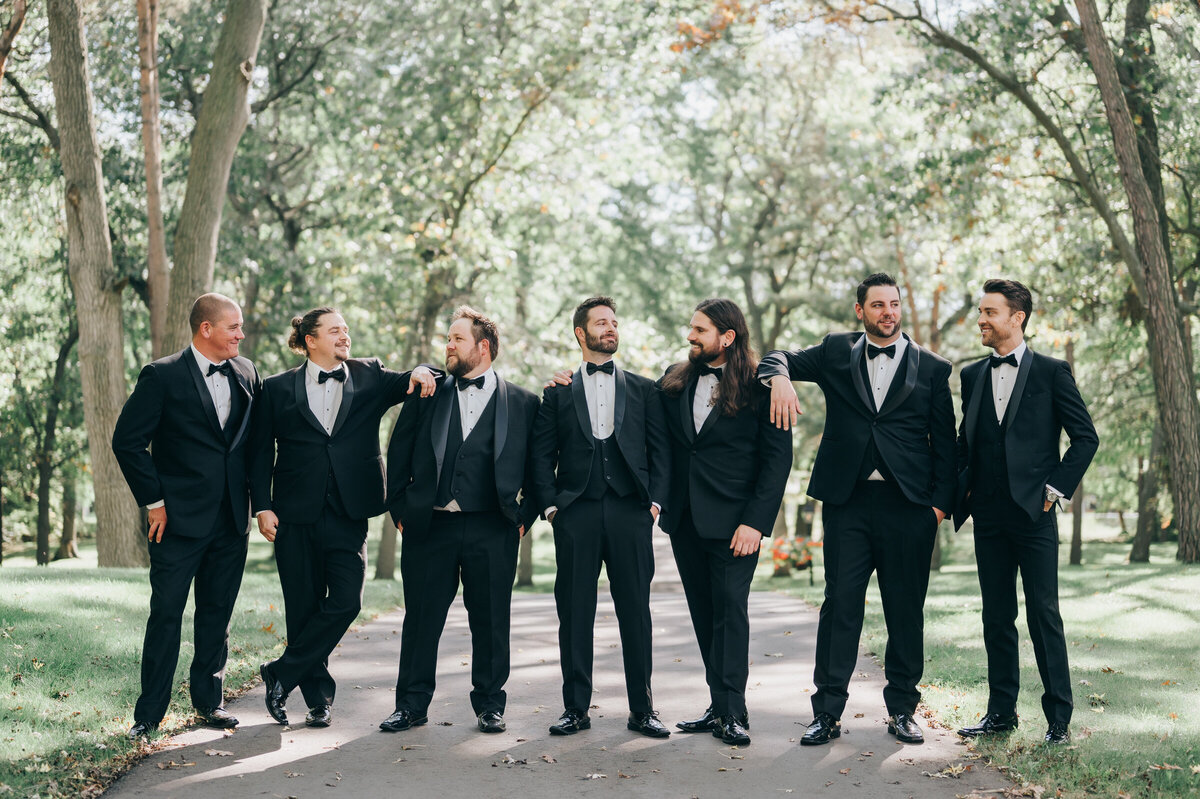 Outdoor portraits of groomsmen in charcoal suits photographed by Nova Markina