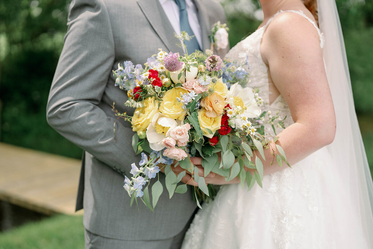 Detailed close-up of the bride’s white and green bouquet photographed at The Blue Heron Barn wedding.