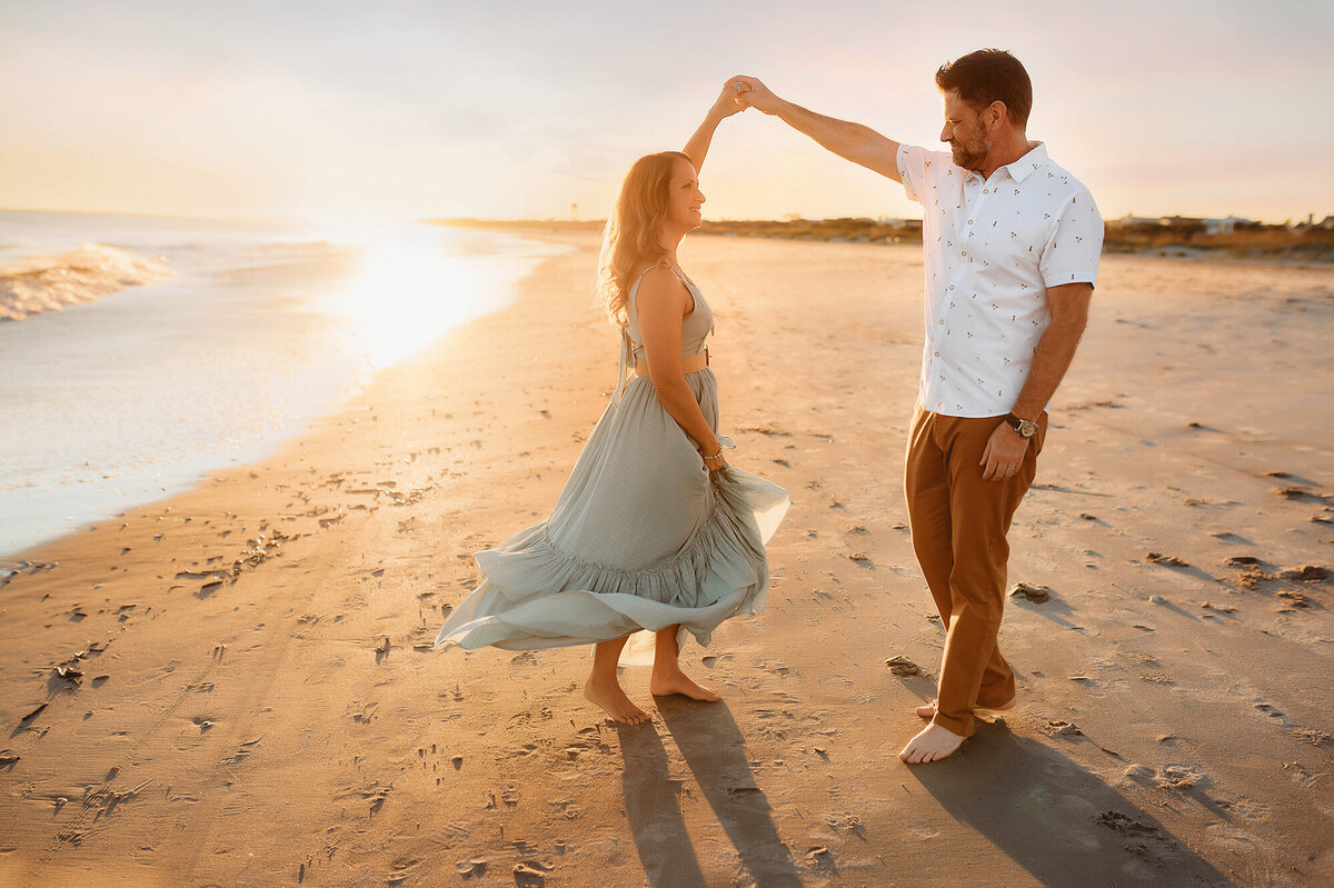 Couple dances on the beach during Family Portraits in Isle of Palms, South Carolina.