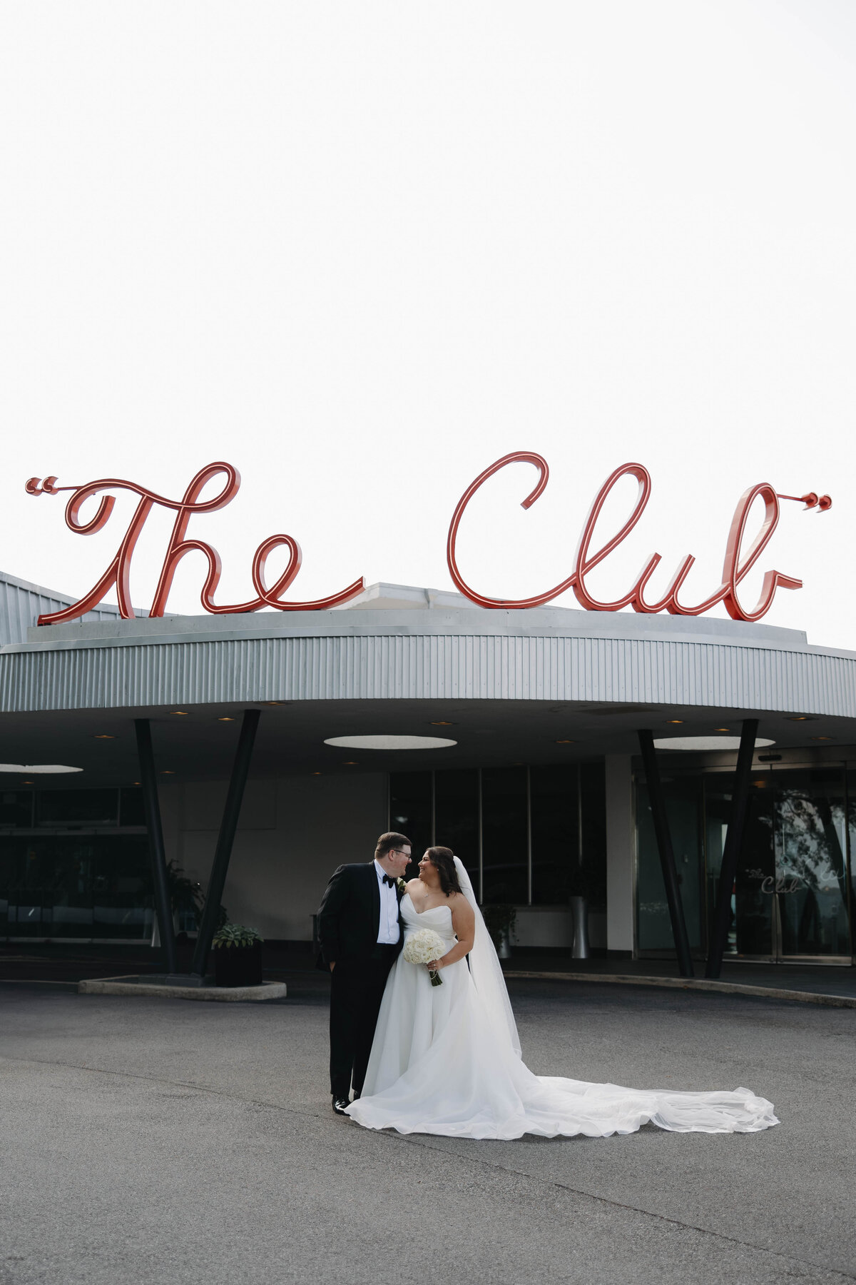 Bride and groom walking out of The Club in Birmingham, AL