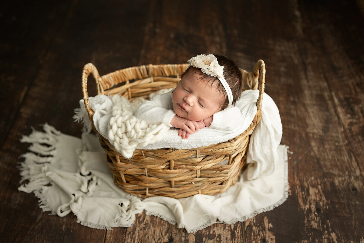 hilliard-ohio-newborn-photographer-near-me-baby-girl-in-woven-basket-with-white-cream-blanket-layers