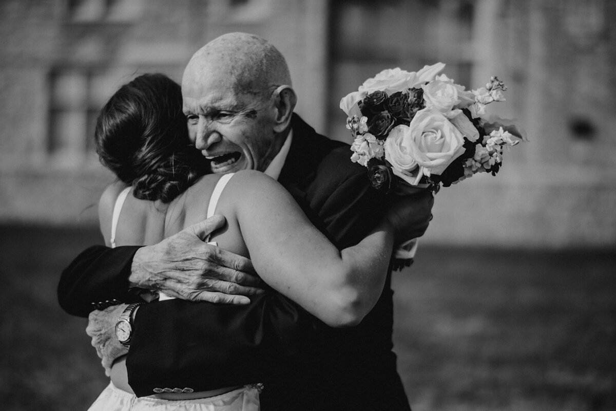 grandpa hugs bride after her ceremony at branford house wedding photo by cait fletcher photography