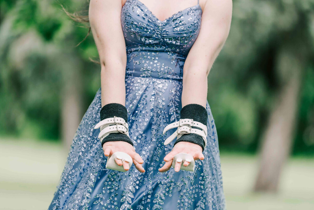 A girl wearing her grips for gymnastics. 