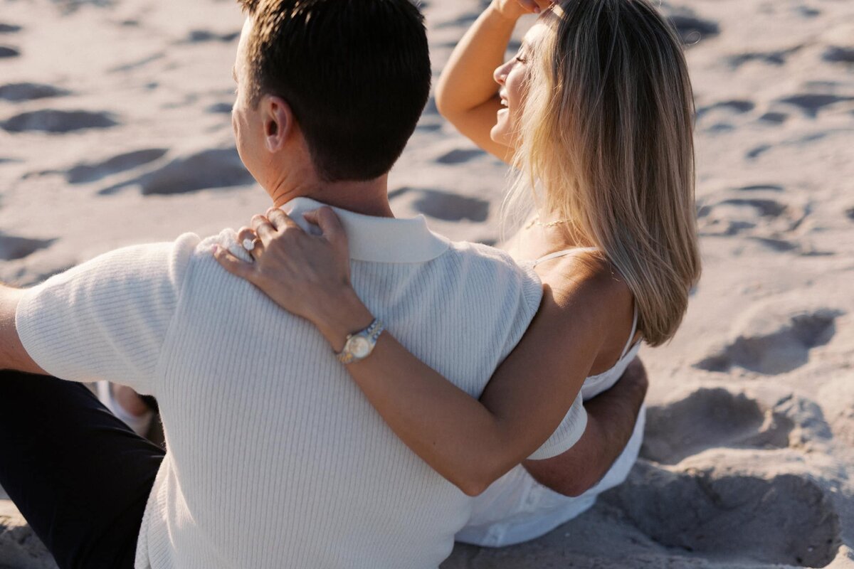 couple sitting on the sand at sunset - cape may nj