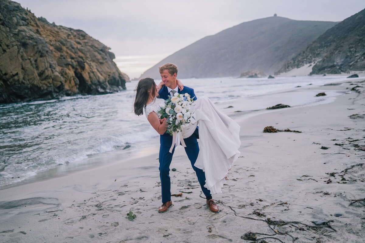 Lake Tahoe wedding photographer captures beach wedding with groom lifting bride during bridal portraits
