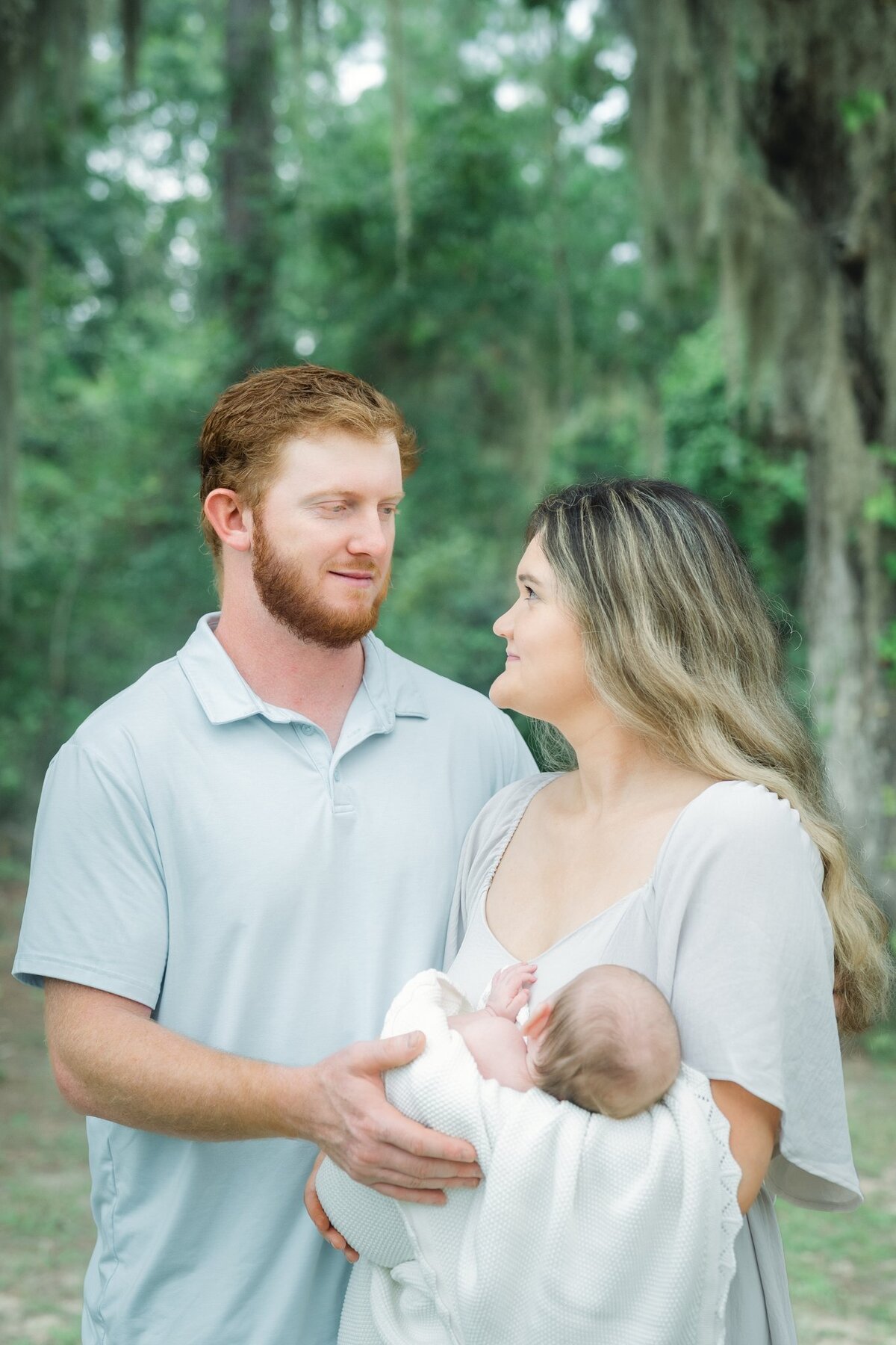 Mom-and-Dad-Holding-Baby-Looking-at-Each-Other-Bainbridge-Tallahassee.jpg