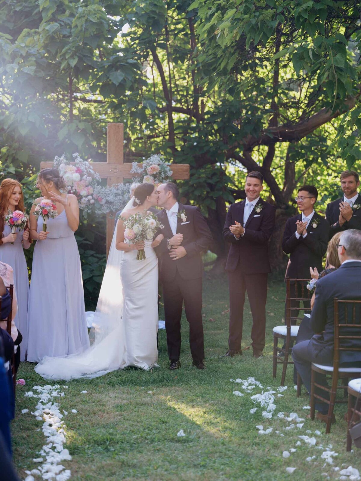 Outdoor wedding ceremony under clear blue sky.