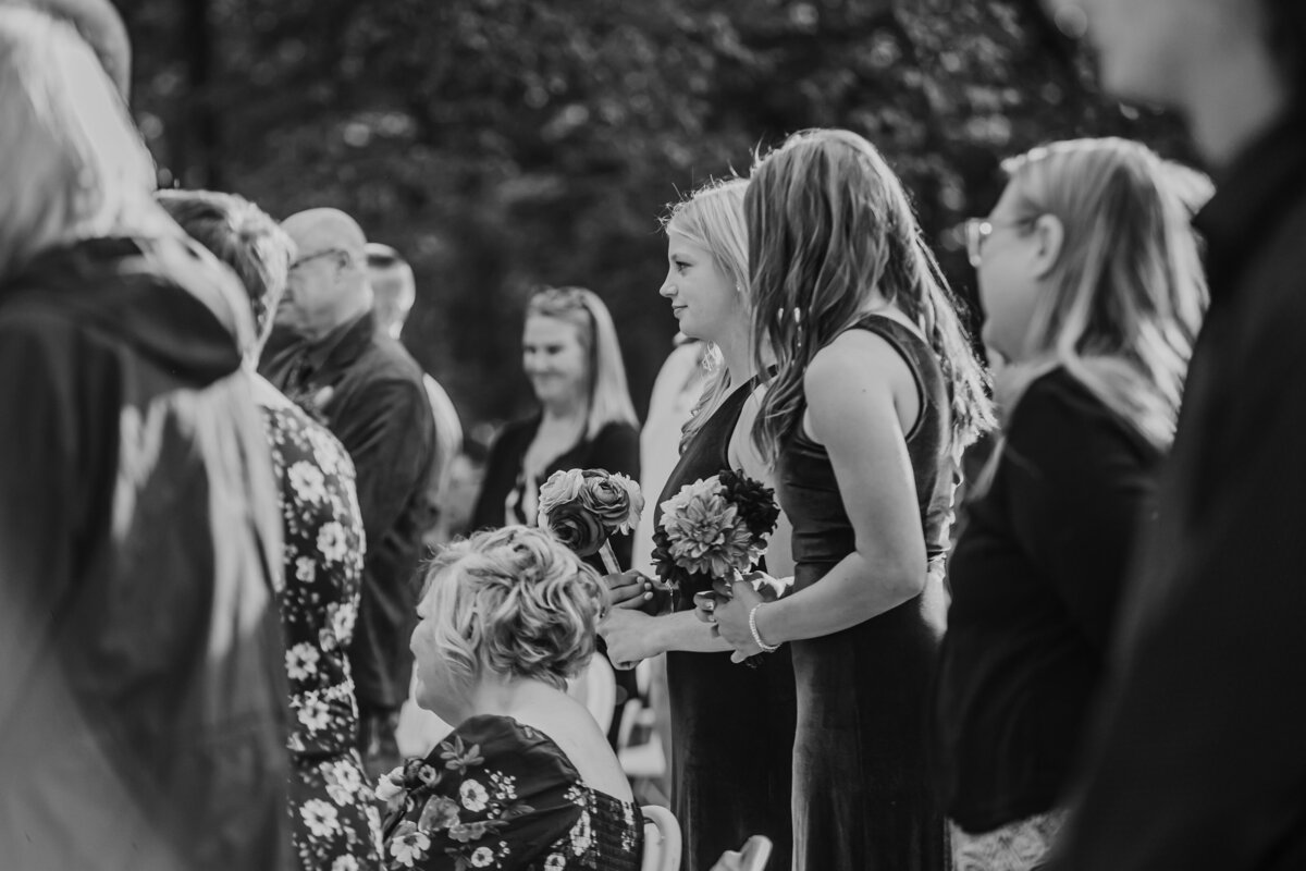 wedding-guests-black-and-white-candid-walnut-woods-state-park-west-des-moines-iowa-storyteller-collective-photo-co