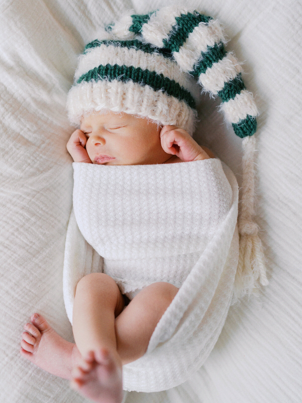 swaddled-newborn-wearing-hat