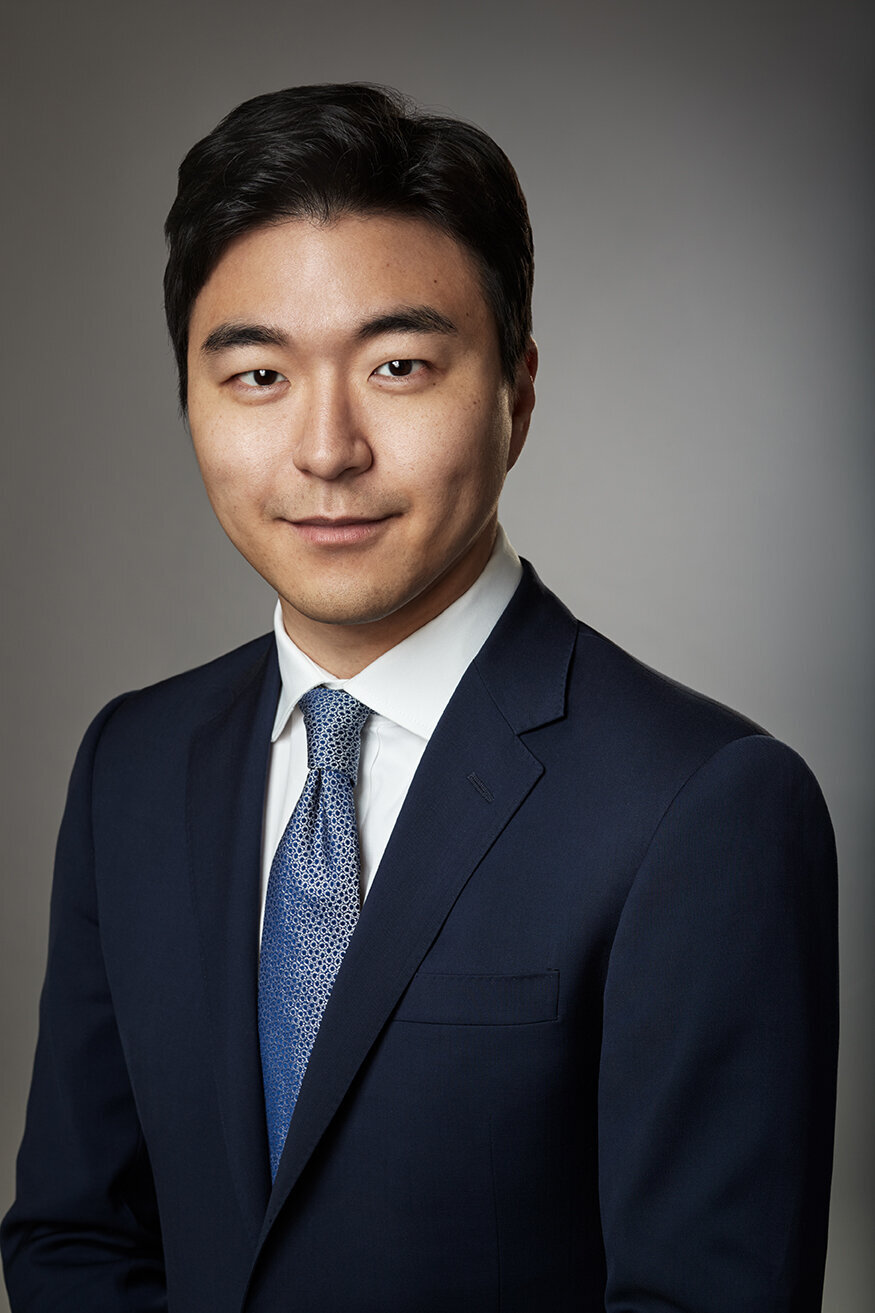 Polished portrait of Andy Han in a blue suit, exuding professionalism, shot by Ylva Erevall.