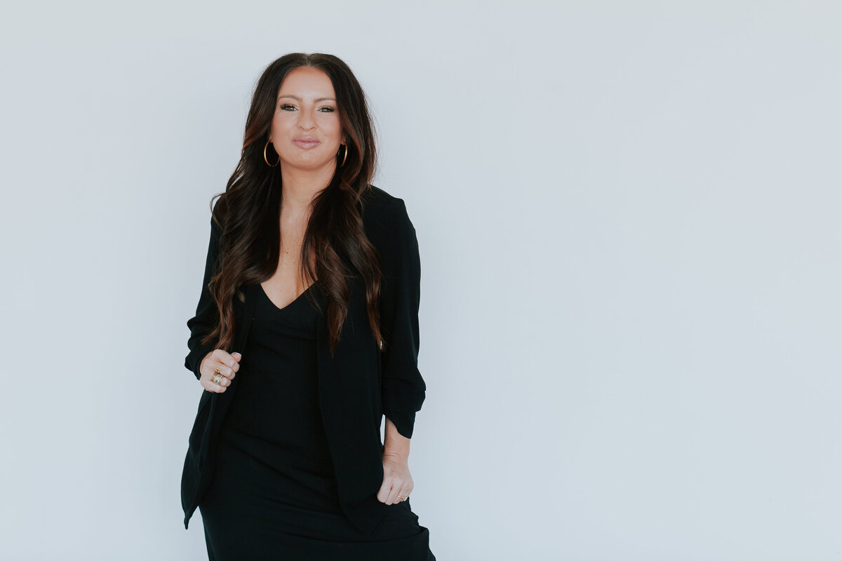 woman-business-owner-negative-space-portrait-black-dress-white-bakcground-for-brand-session-the-frame-charlotte