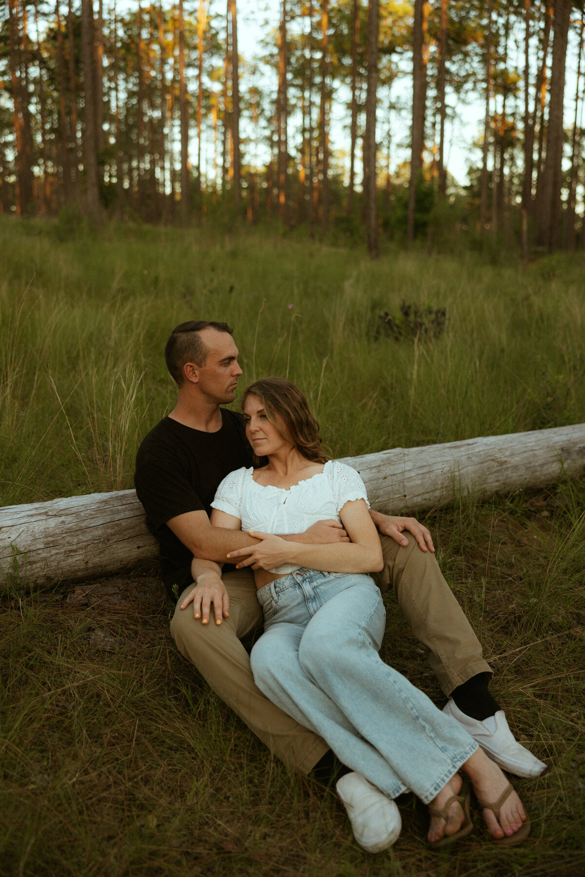 Couple posing for portraits in a forest.