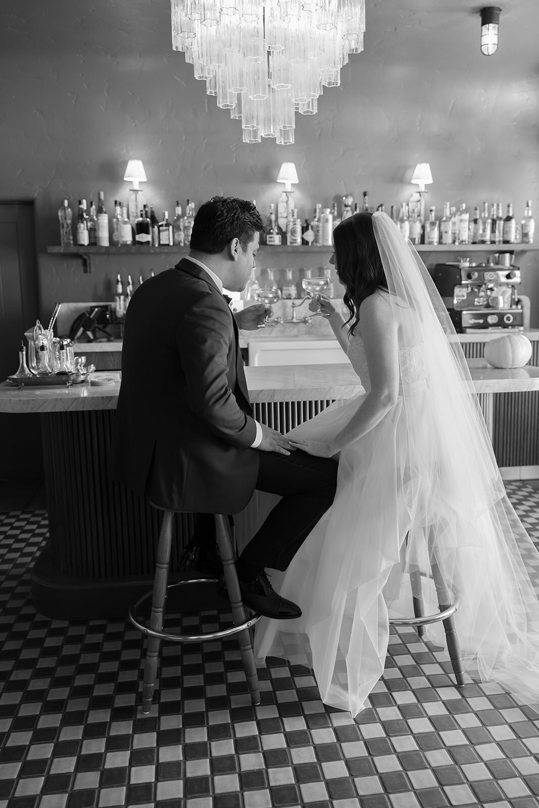 Bride and groom sip their cocktails on their wedding day