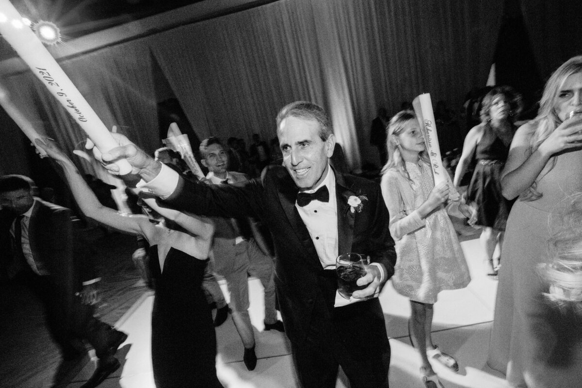 A joyful moment of the father of the bride celebrating on the dance floor, adding energy and excitement to the wedding reception.