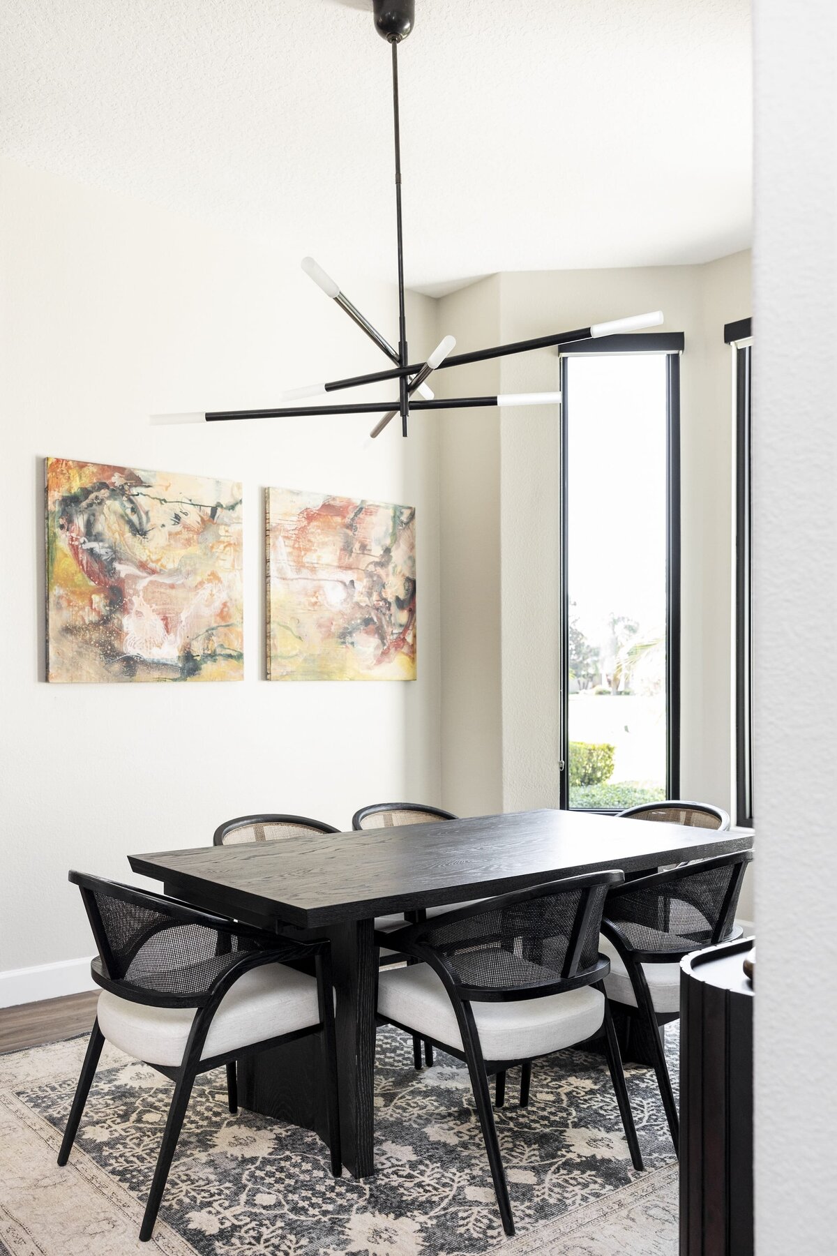 dewine design orlando interior designer windermere full home renovation dining room table with accent rug and paintings on wall