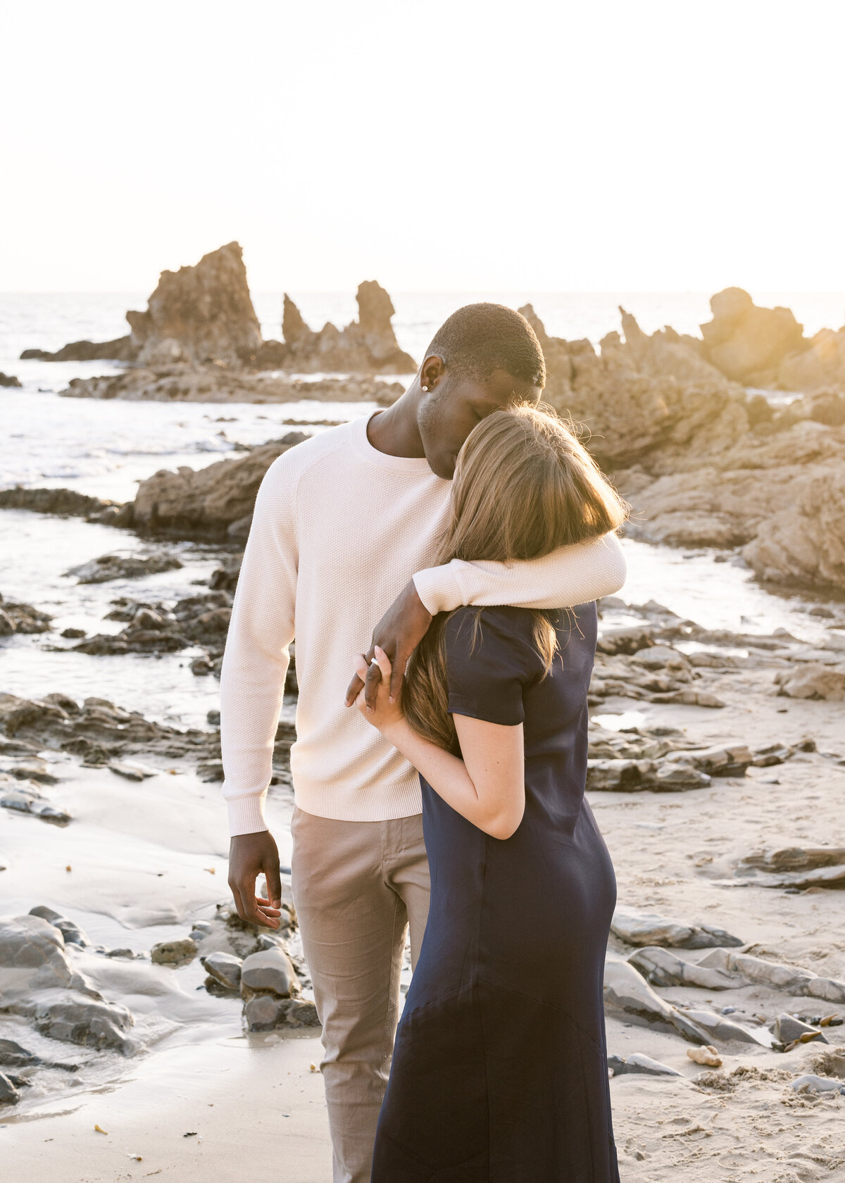 romantic and dreamy photo of couple kissing on the beach