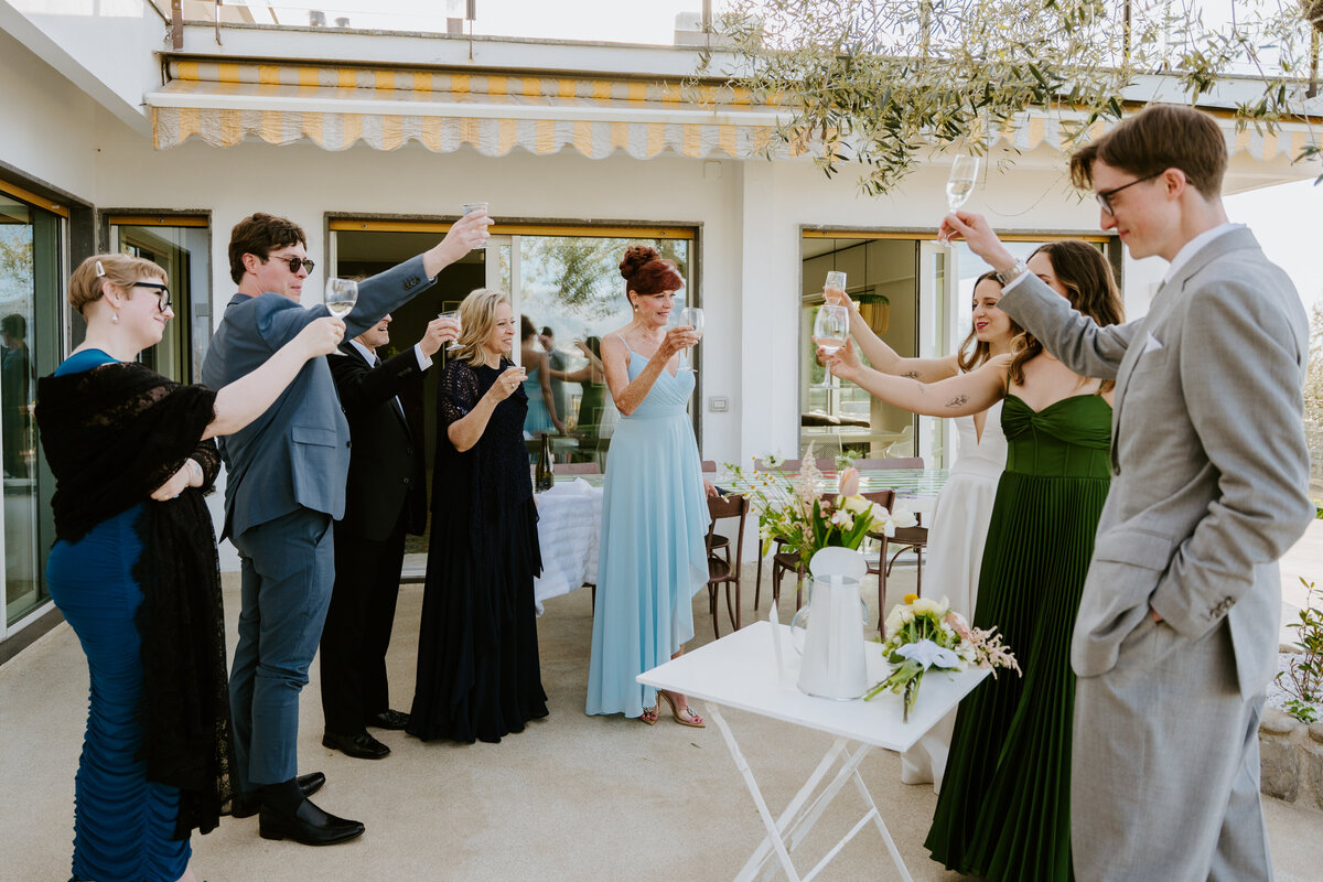 Friends celebrating with champagne on terrace