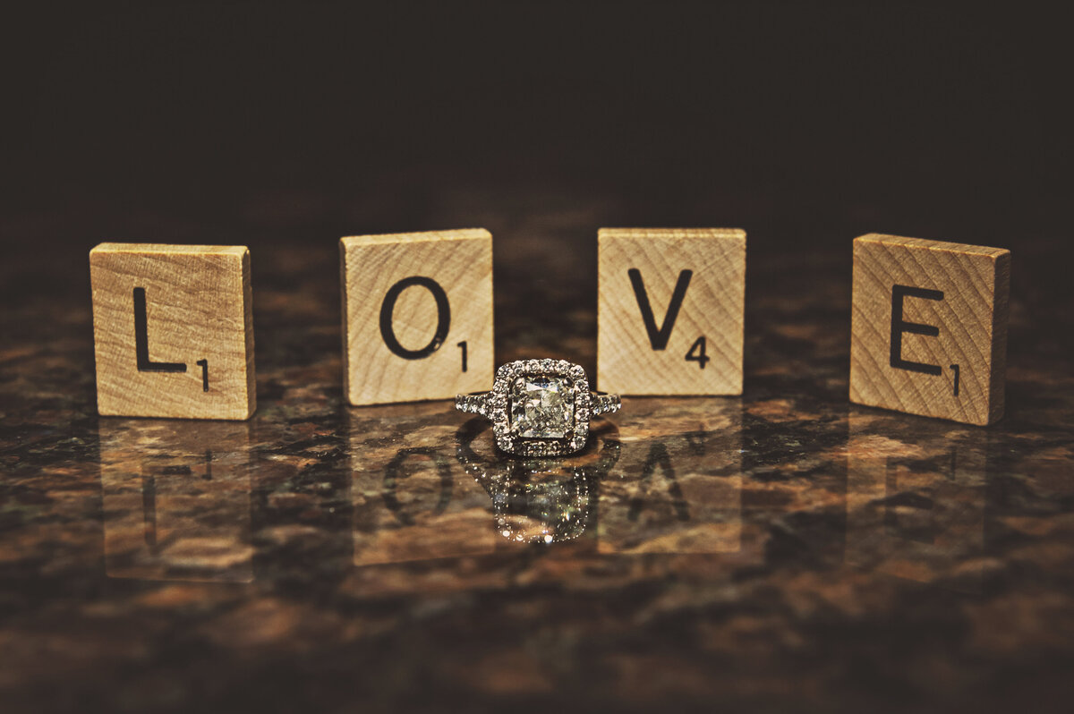 Wedding rings scrabble letters L O V E.