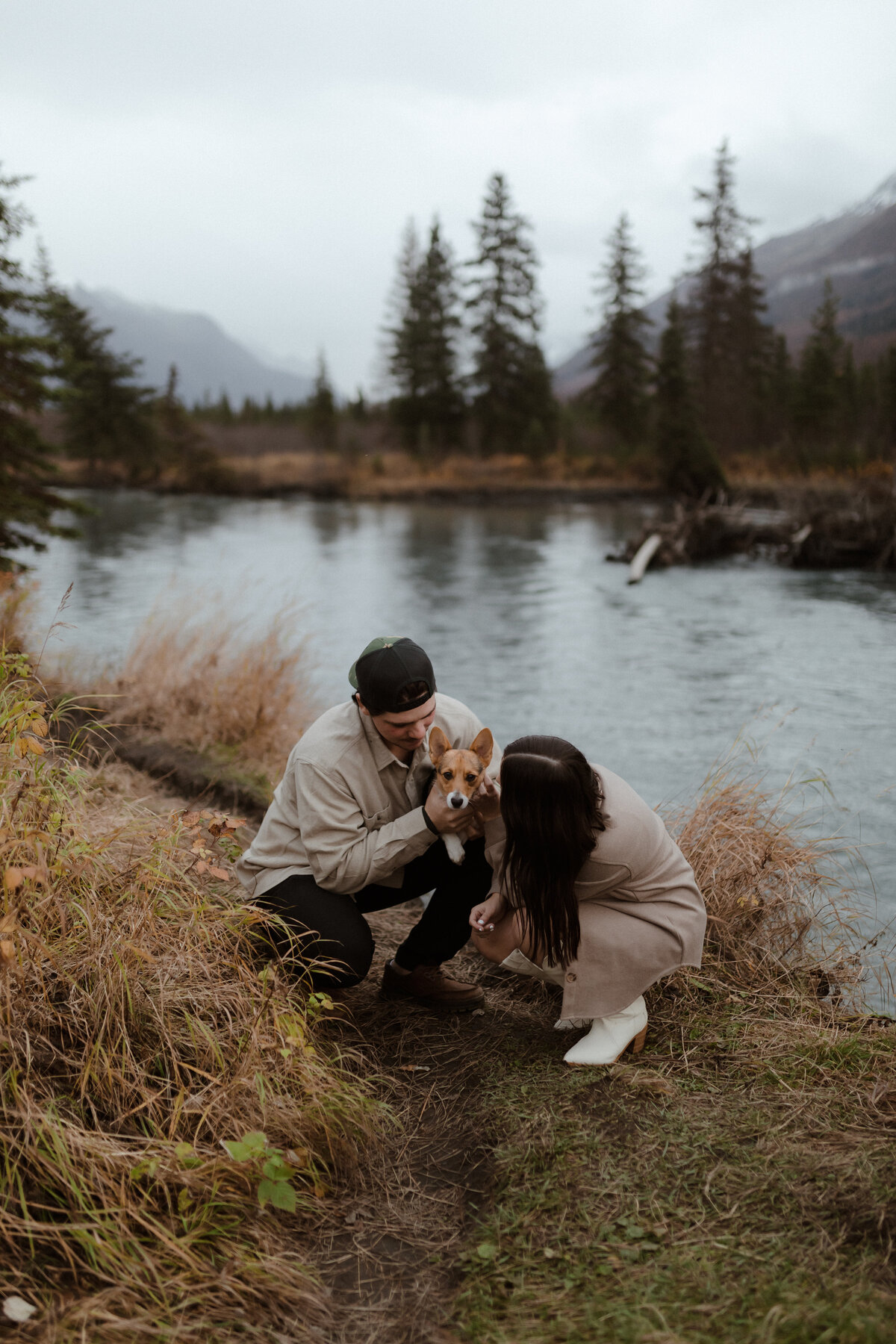 Couple playing with dog