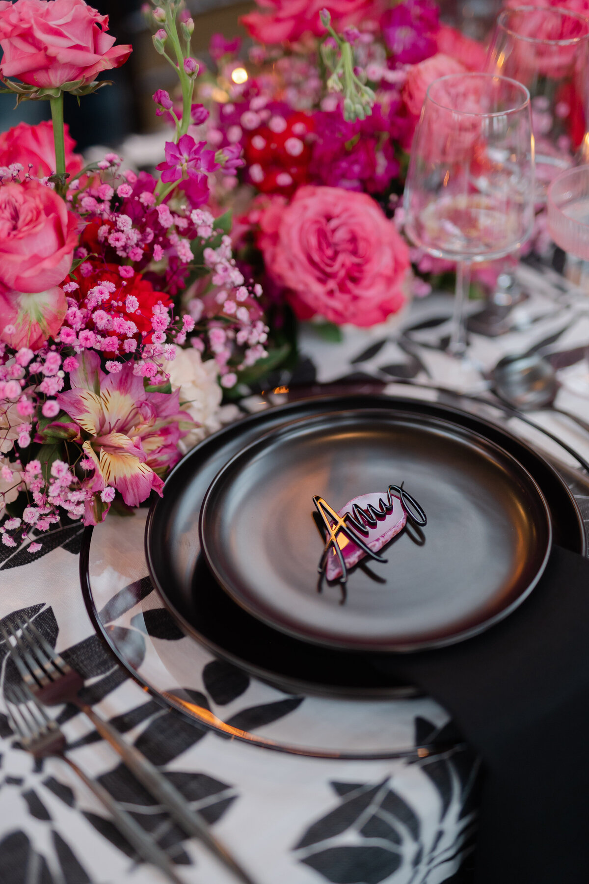 Black and pink wedding tablescape of plate closeup