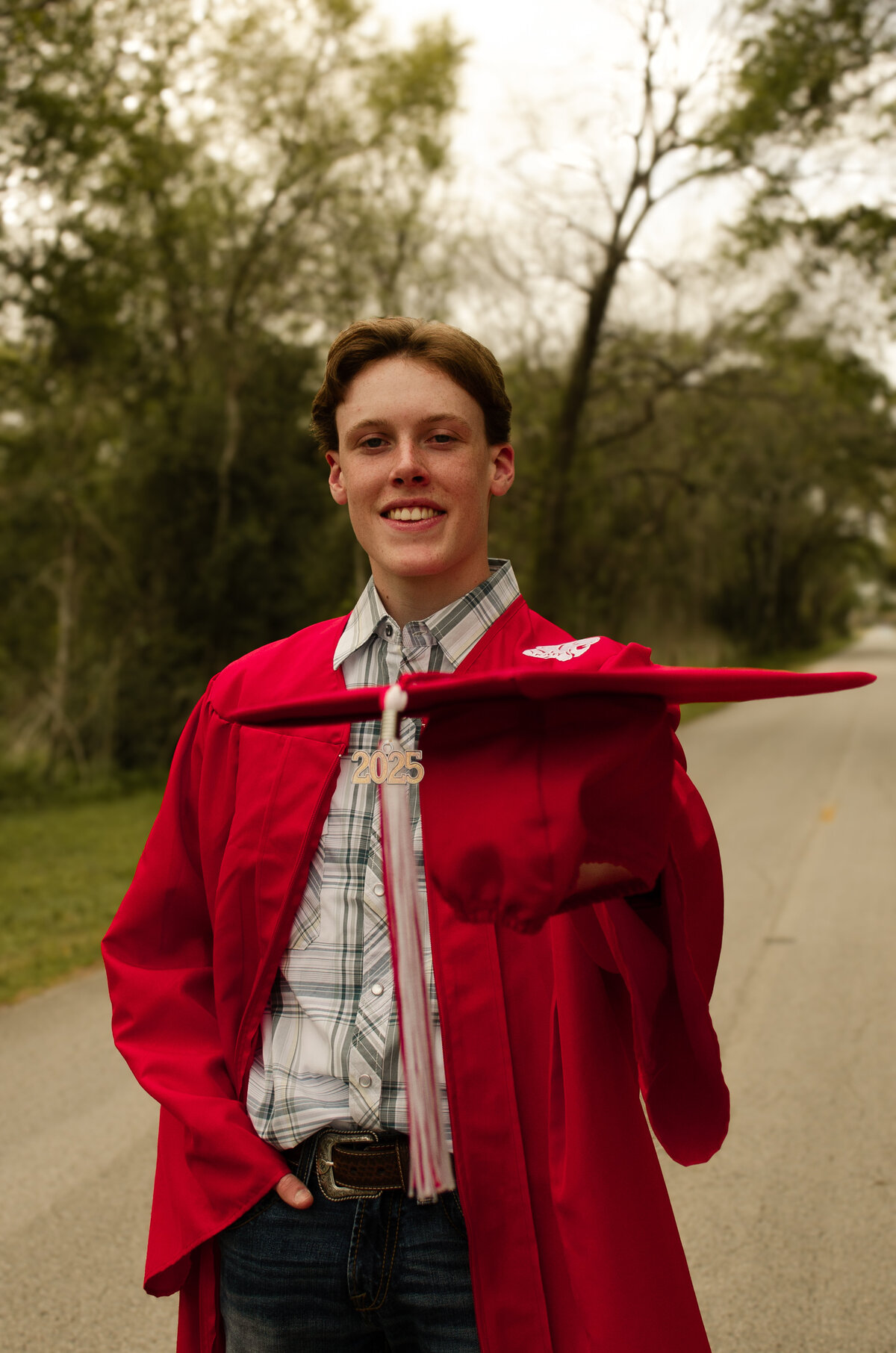 Senior boy poses cap and gown