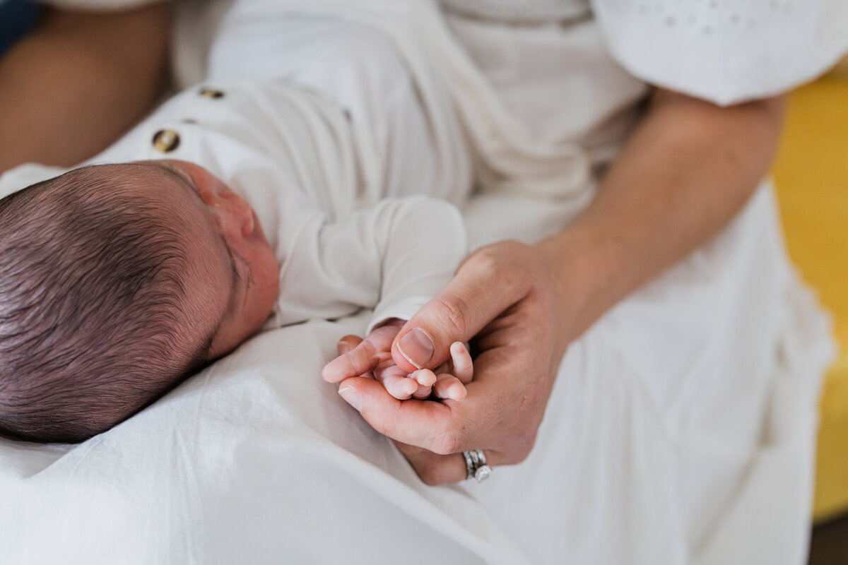 mom-holding-baby-hand